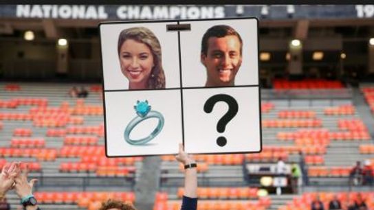 Auburn staffer proposes before game using sideline play sign (Auburn)