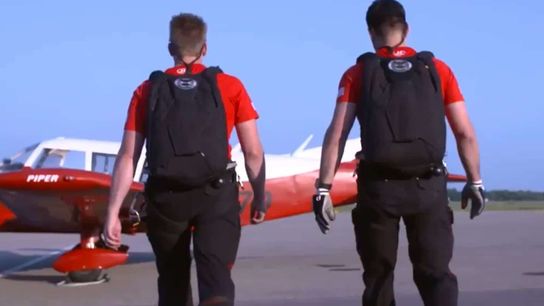 PJ Fleck brings a Navy Seal and has two guys jump out of a plane to parachute a "letter from the president" in for a #ScholarshipAlert (Minnesota)