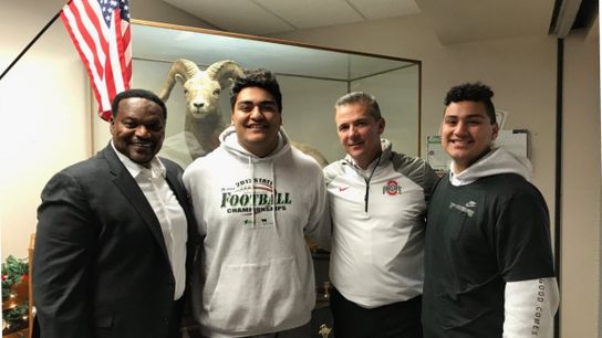 Video: Urban Meyer and Larry Johnson jump out of their seats to celebrate a commitment in a recruit's living room (recruiting)